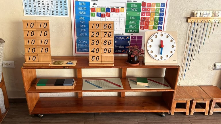 Wooden classroom storage shelf with educational math posters and teaching tools displayed on the wall above it