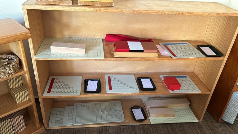 Wooden shelving unit displaying multiple notebooks, journals, and notepads arranged on three shelves